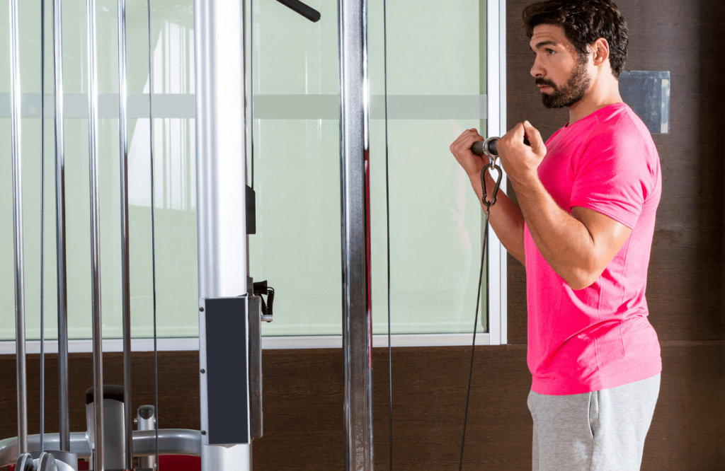 A man targeting biceps during a cable arm workout