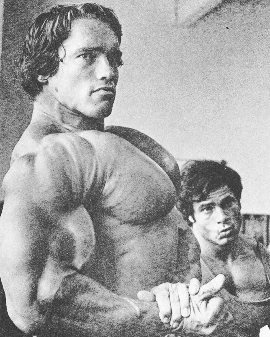 Young Arnold Schwarzenegger flexing muscles