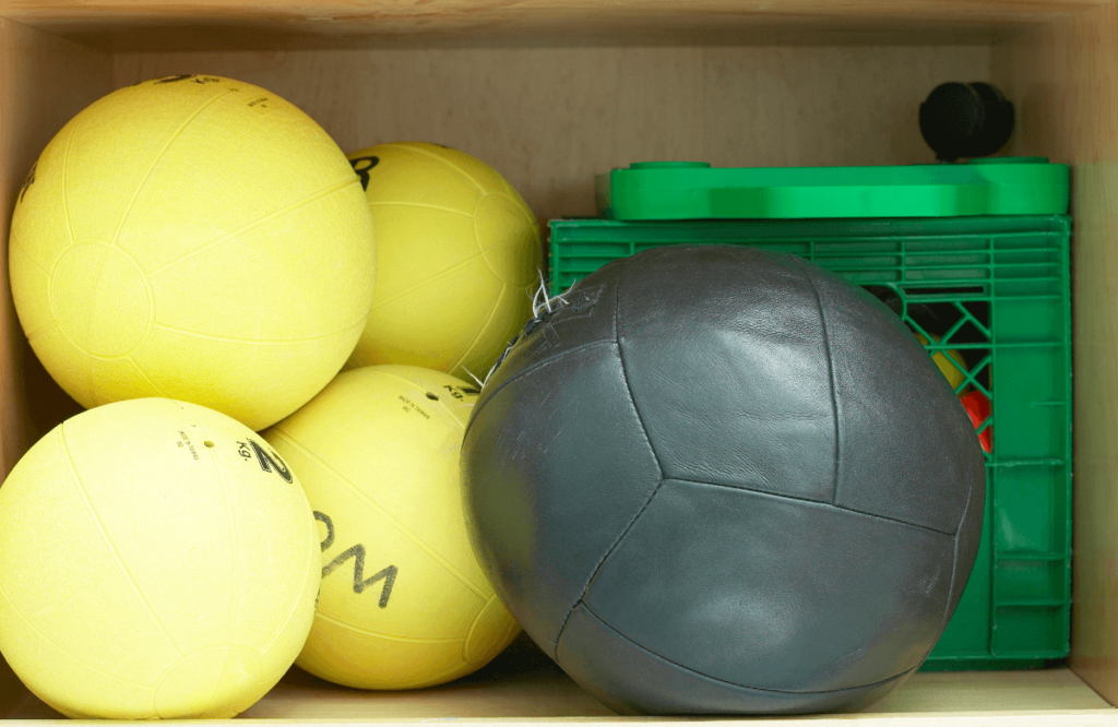 A cabinet used to store balls in a home gym