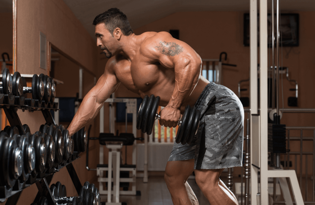 A strong man doing dumbbell back exercises