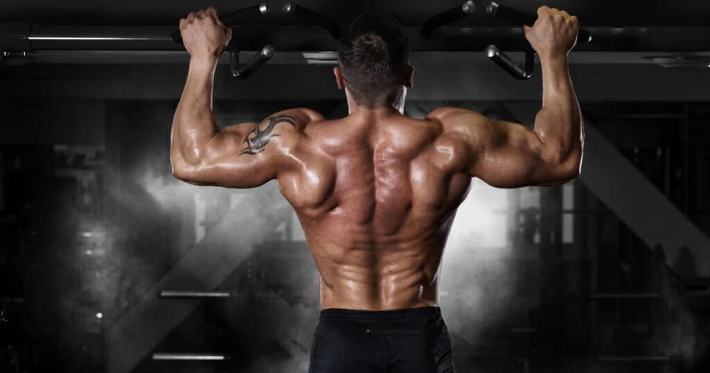 Photo Muscular Man Working Out In Gym, Doing Stomach Exercises On