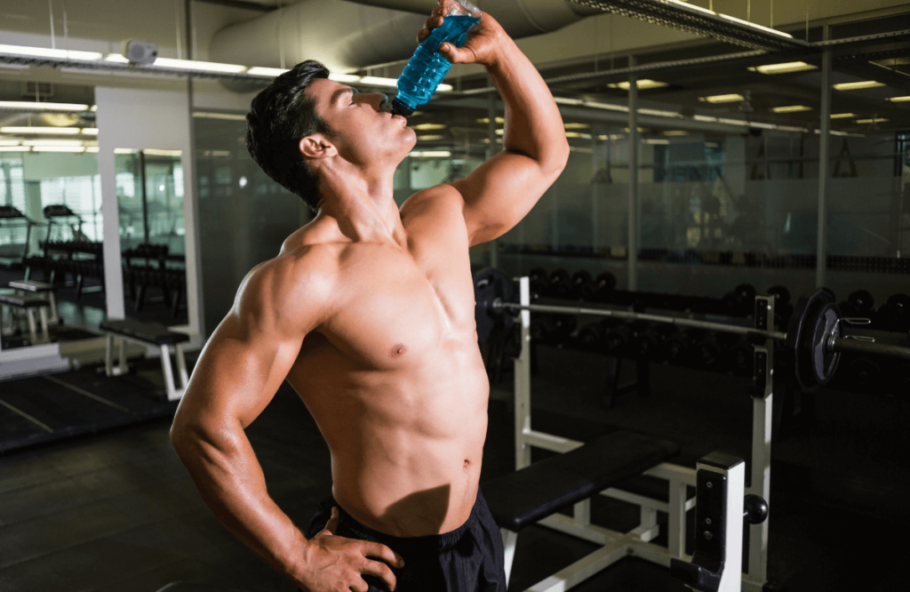 A man with the ideal male body at the gym