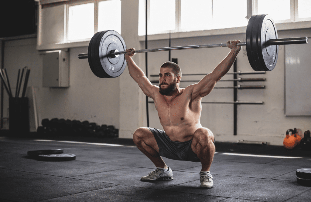 A powerful man wearing the best weightlifting shoes