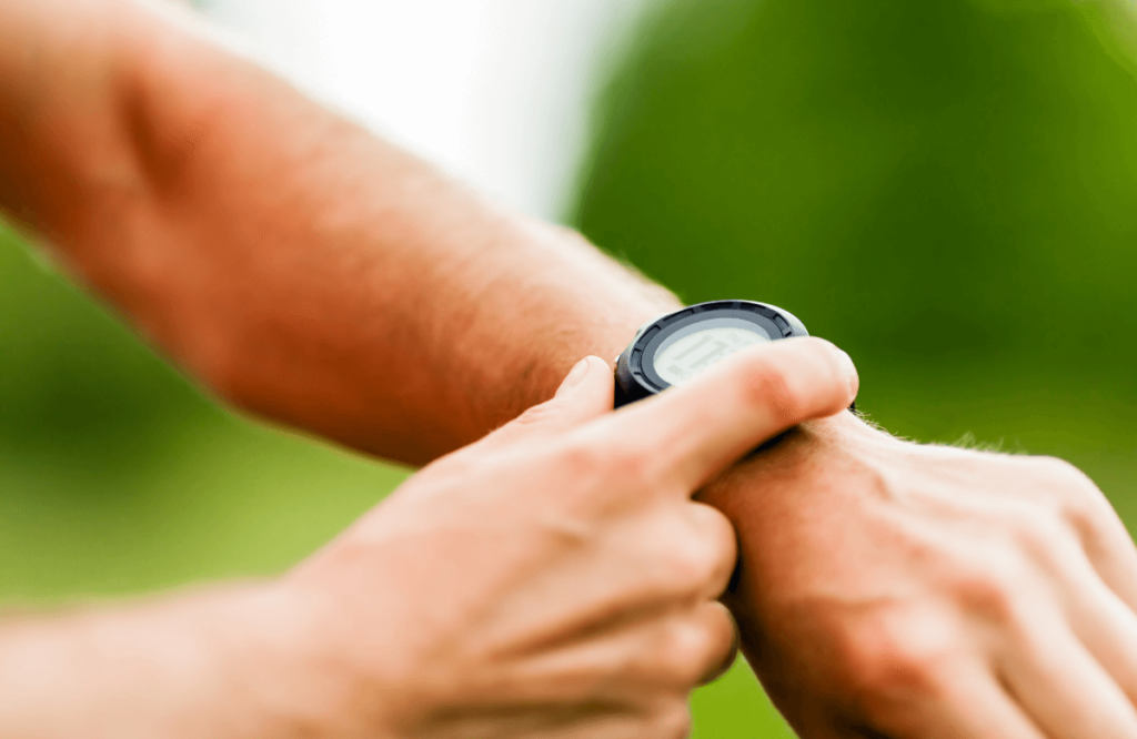 A man using one of the best sports watches for men outside