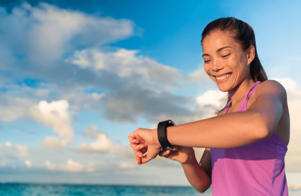 A woman running close to the beach using one of the best sports watches