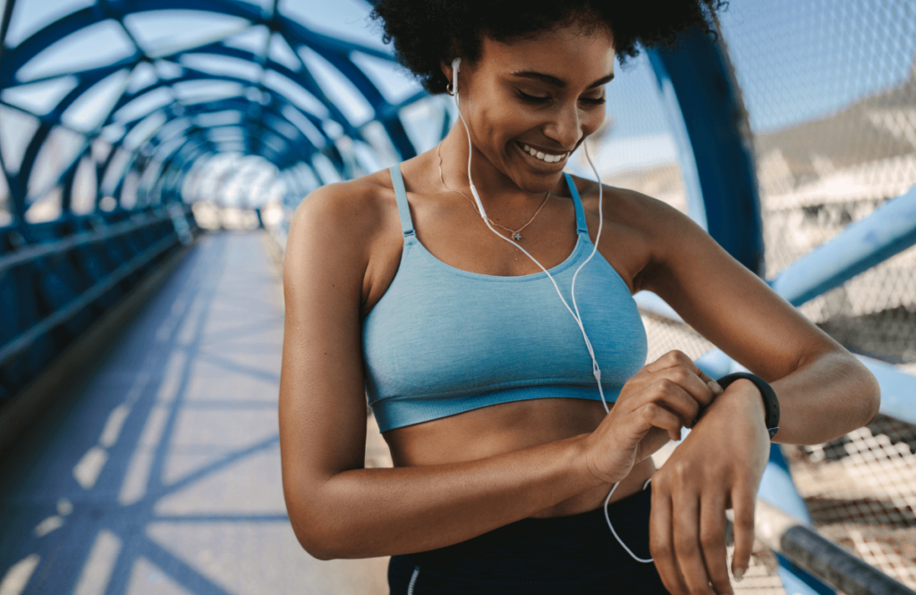 A woman running on a bridge using one of the best sports watches