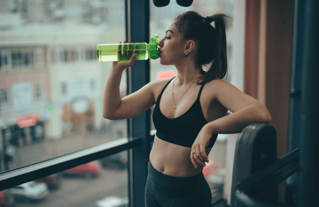 A woman drinking water to stay hydrated