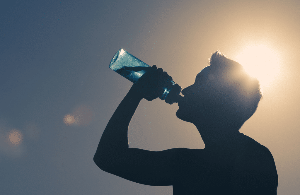 A man drinking water to improve his protein weight gain