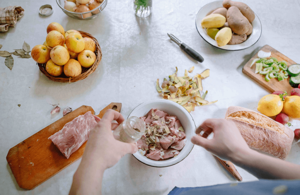 A man cooking pork during his meal prep