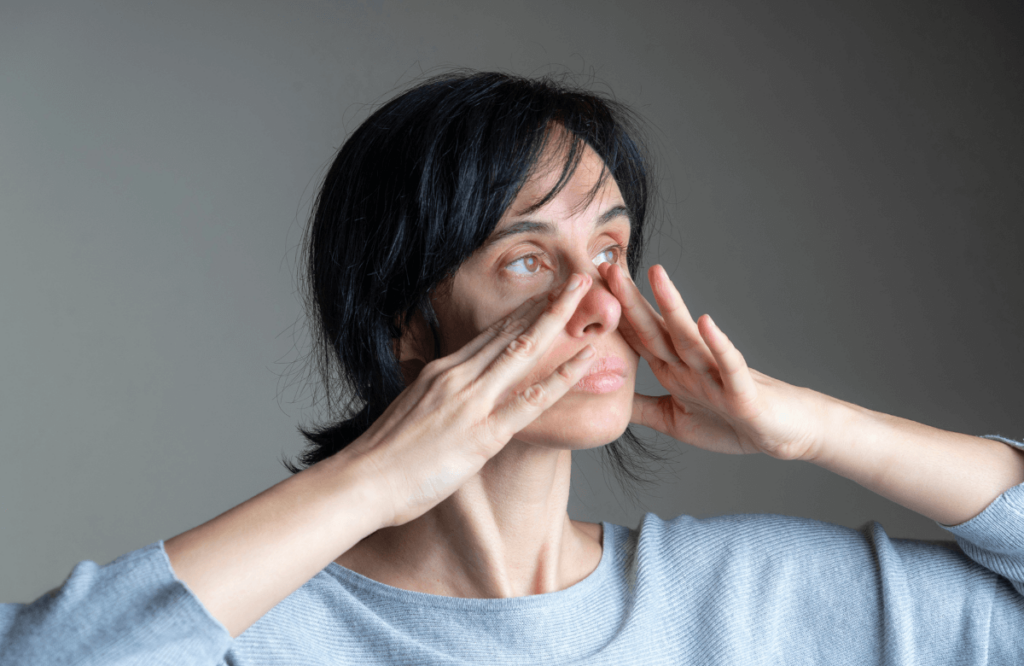 A woman doing face exercises to lose face fat properly