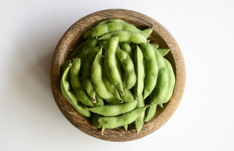 Young soy beans or edamame on white background.