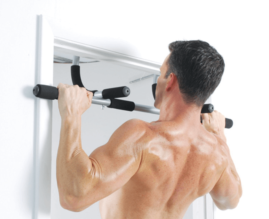 Man does pull ups on home pull up bar