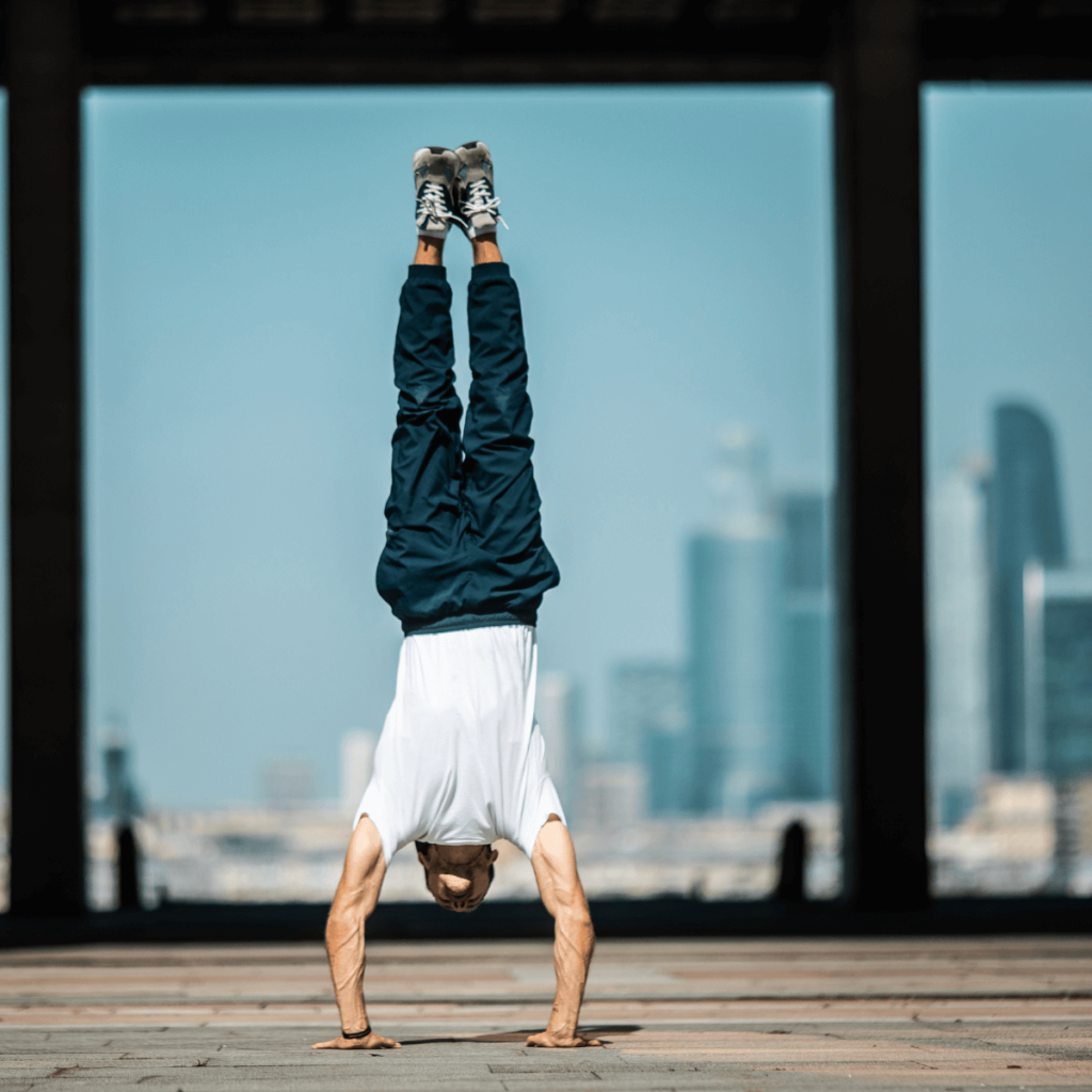 A man does calisthenics moves in front of skyline