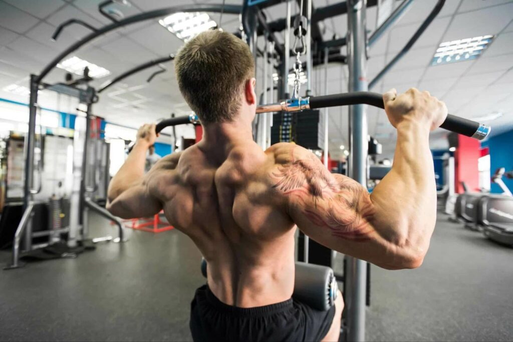 A man does lat pulldowns in a gym
