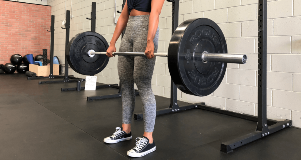 A woman wears converse for lifting