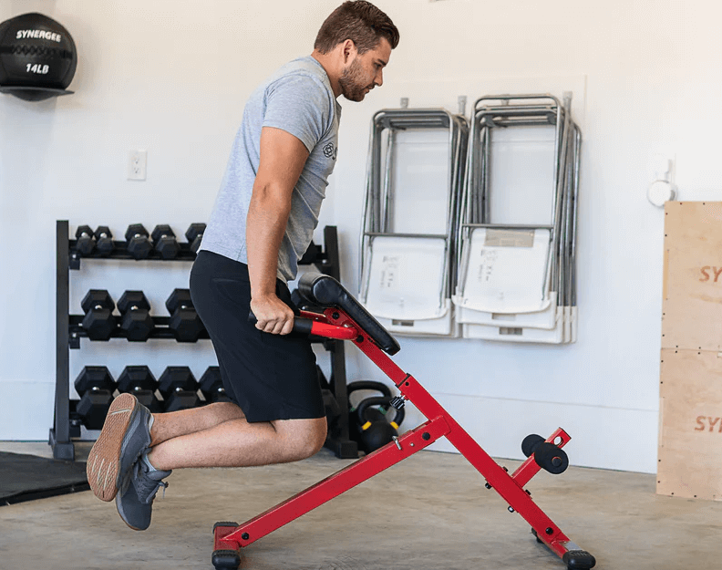 A man does dips on a roman chair