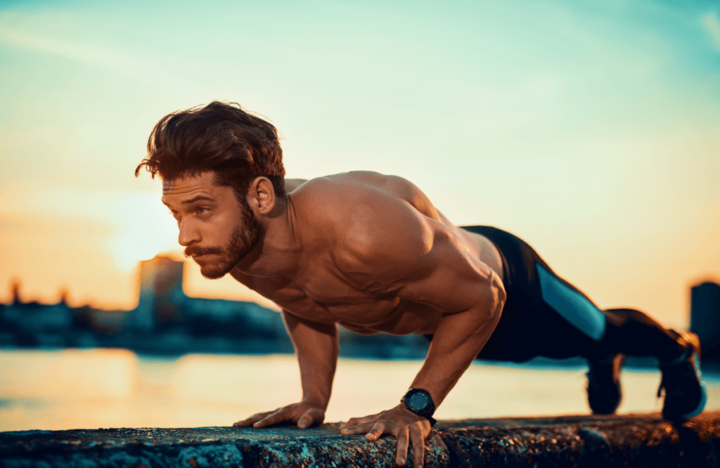 A man does diamond push-ups in a park