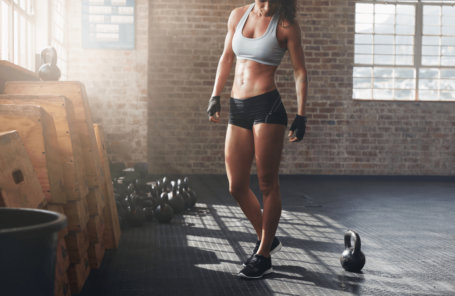 Woman wears crossfit grips in a gym