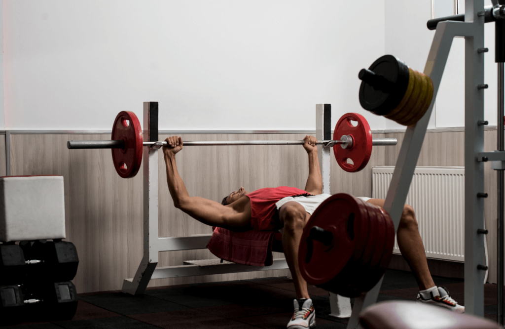 Man does bench press in a gym