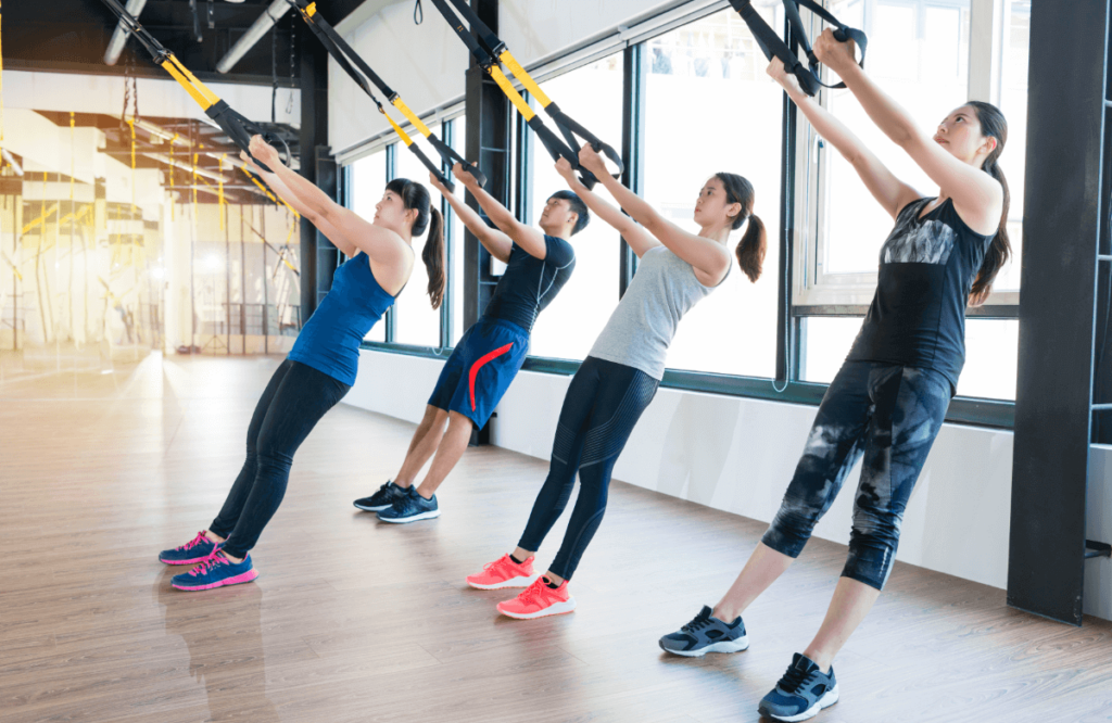 A group of person does a trx workout