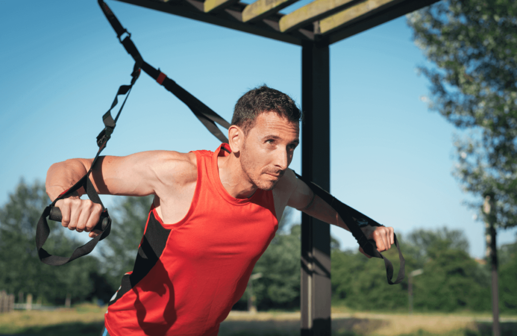 A man does a push-up workout on trx workout