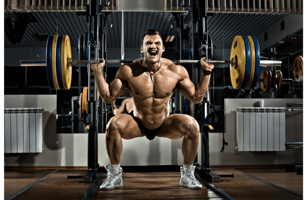 Muscular shirtless man man squatting in gym