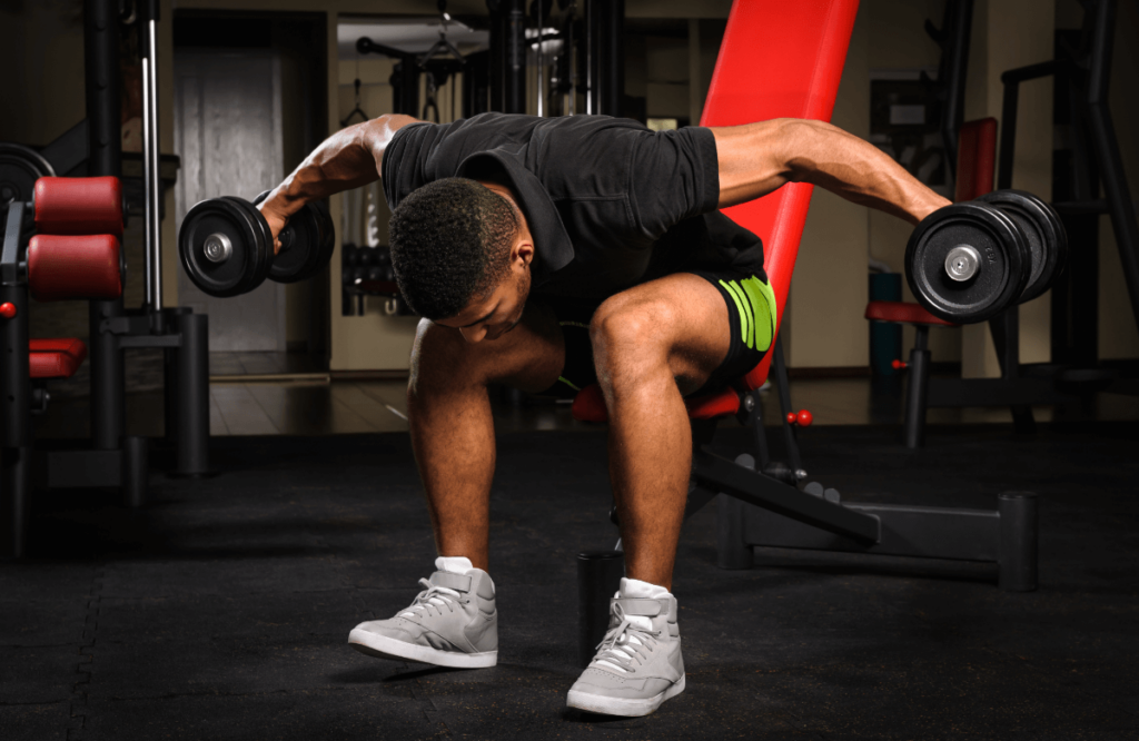 A man does reverse flies in a gym