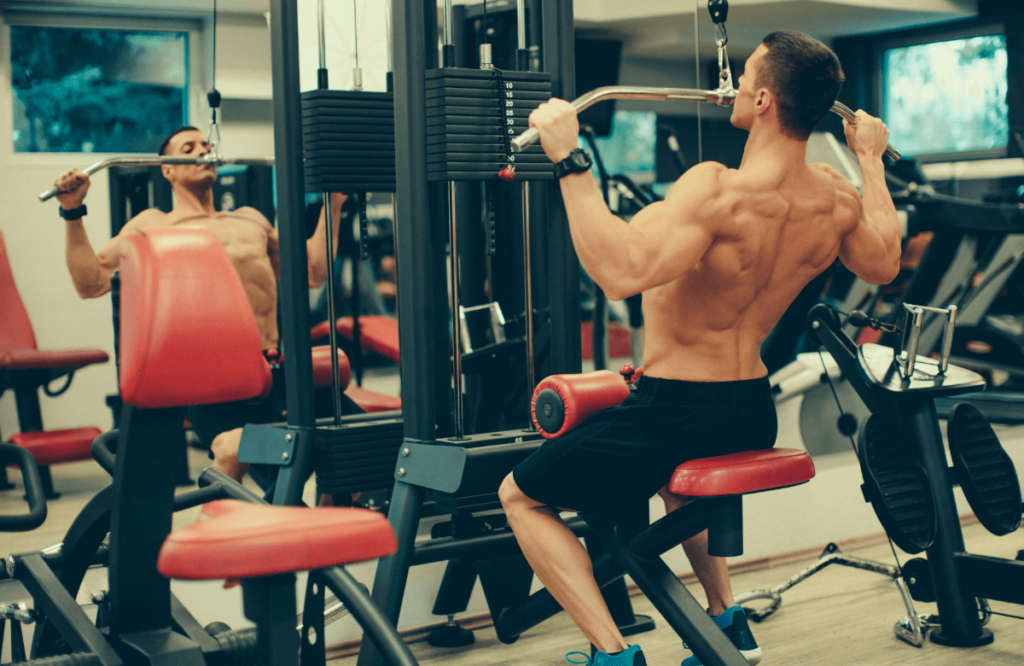 Fit man does lat pulldowns in gym