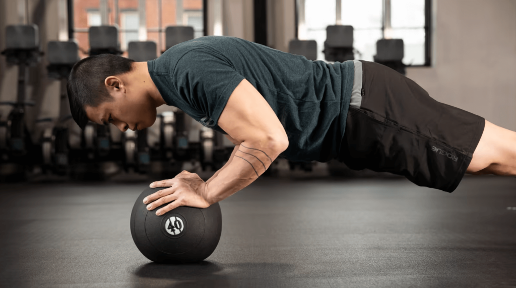 A man does push-ups on a medball