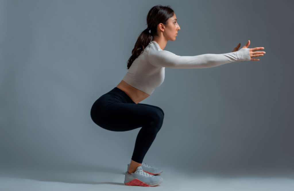A woman does an air squat