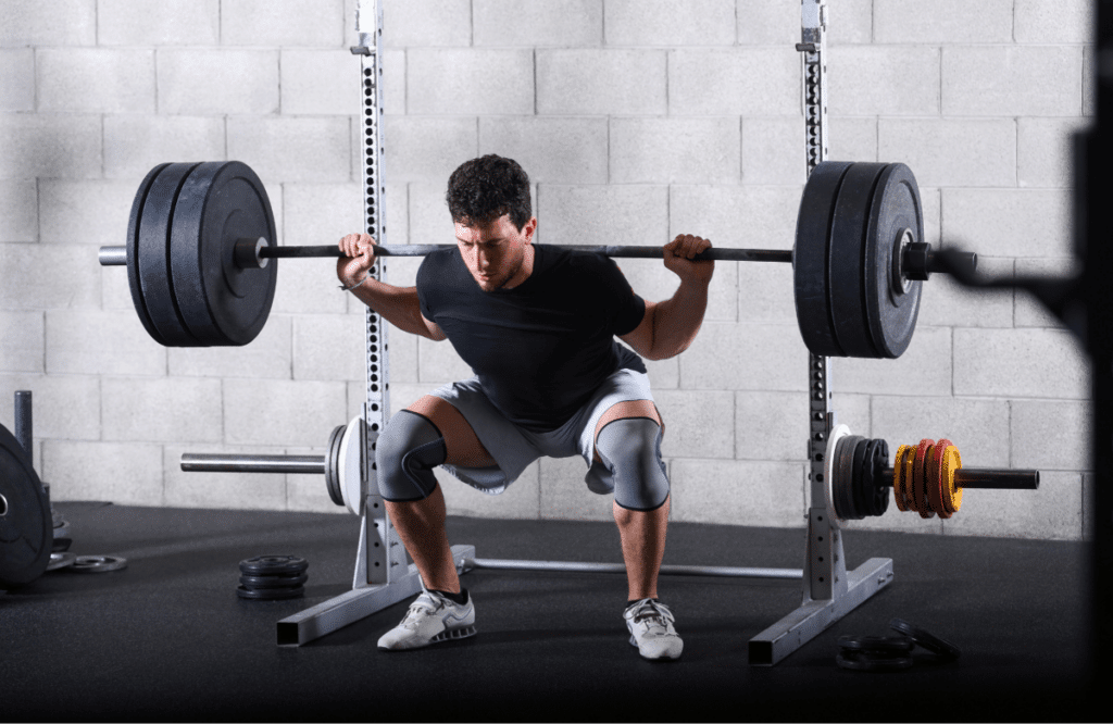 A man does a barbell squat