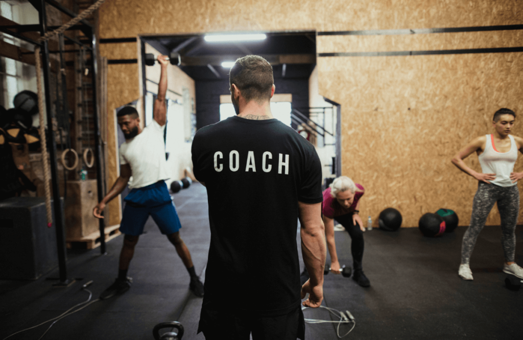A crossfit coach teaches a class