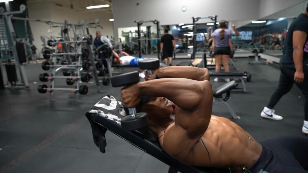 a man does dumbbell tricep extensions