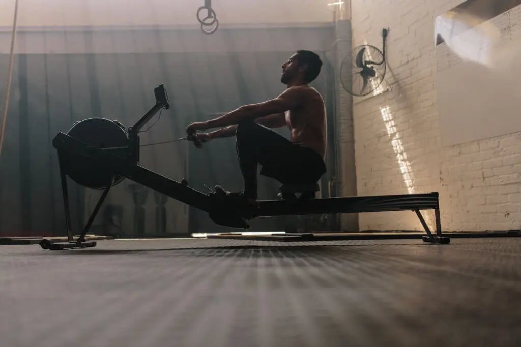 a man is using a rowing machine which is good for his back