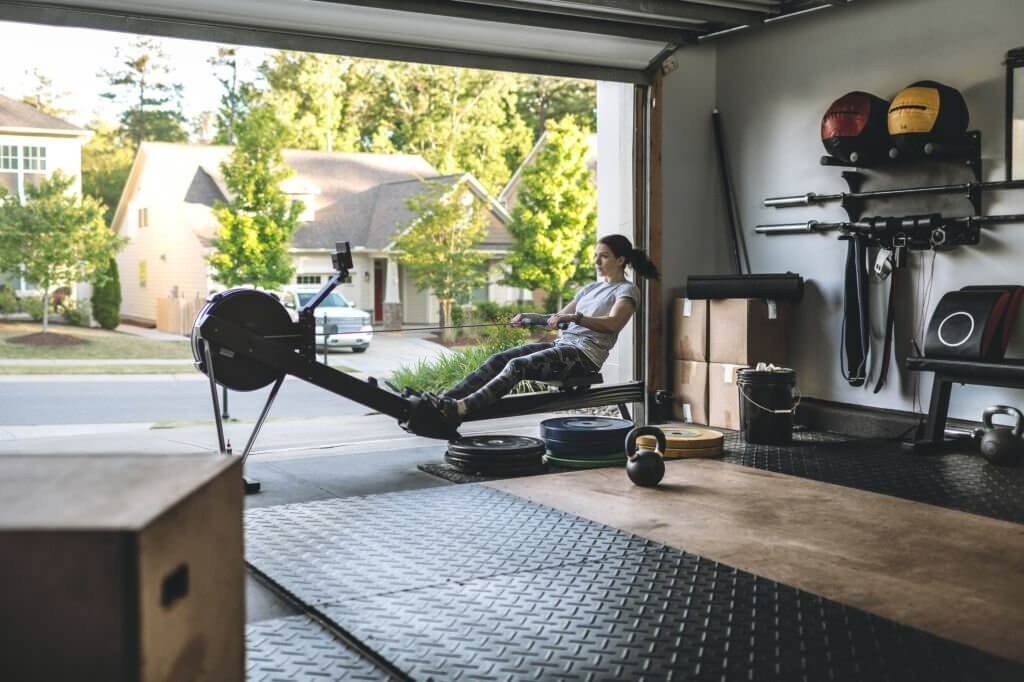 a woman working out its muscles with a rowing machine