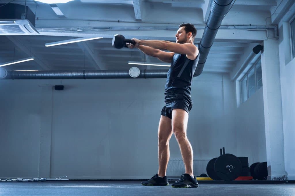 A man is trying to lose weight with kettlebell