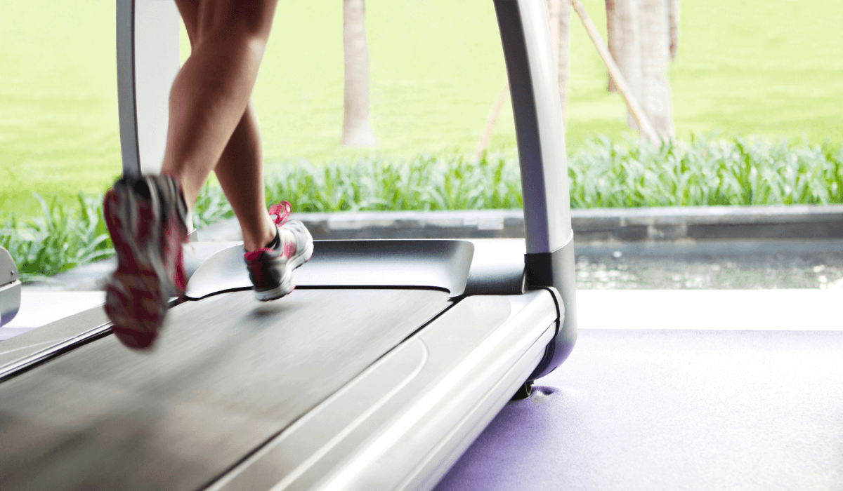 a woman using a treadmill and asking herself how to oil a treadmill