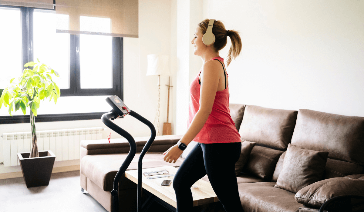 A woman using the whole size of her treadmill at home