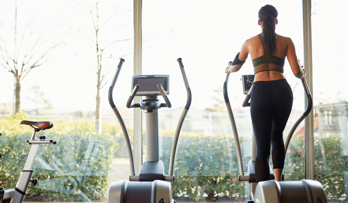A woman running on elliptical at home