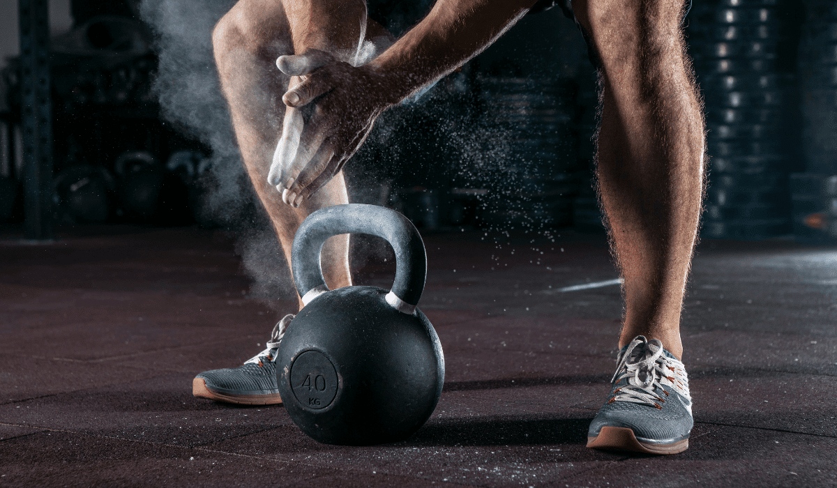 an athlete doing its kettlebell shoulder workout at the gym