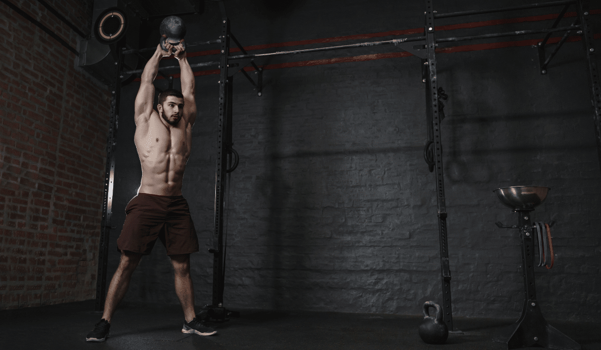 An athlete trying to improve its kettlebell swings form at the gym