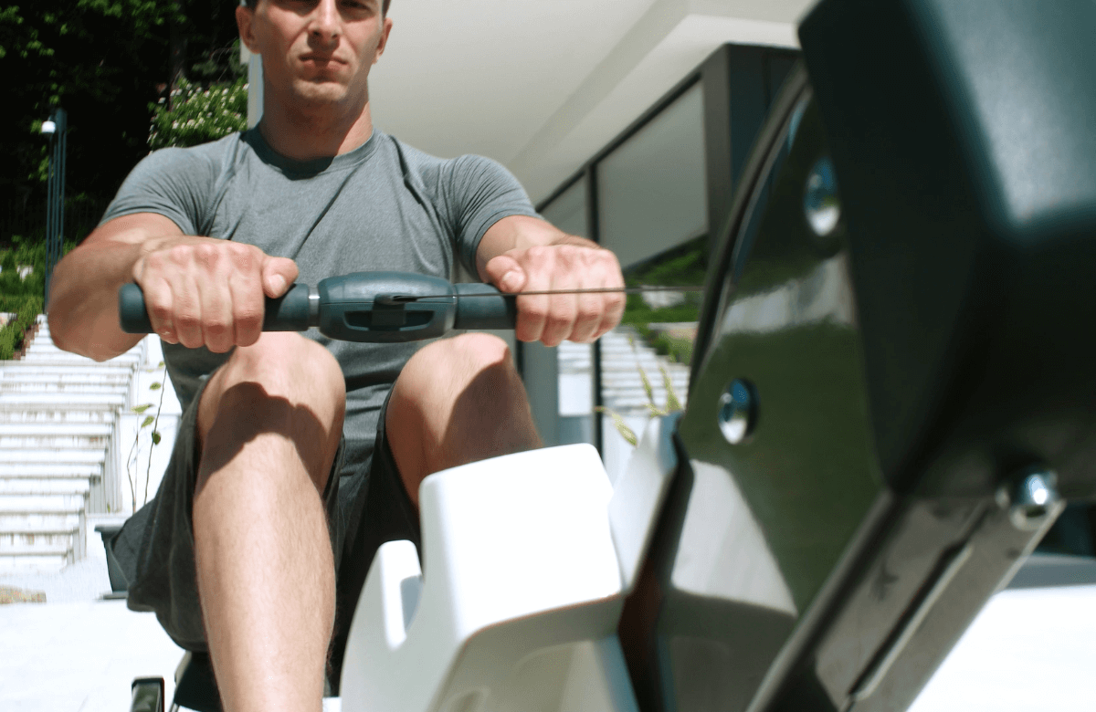 A man working out with the best hydraulic rowing machine
