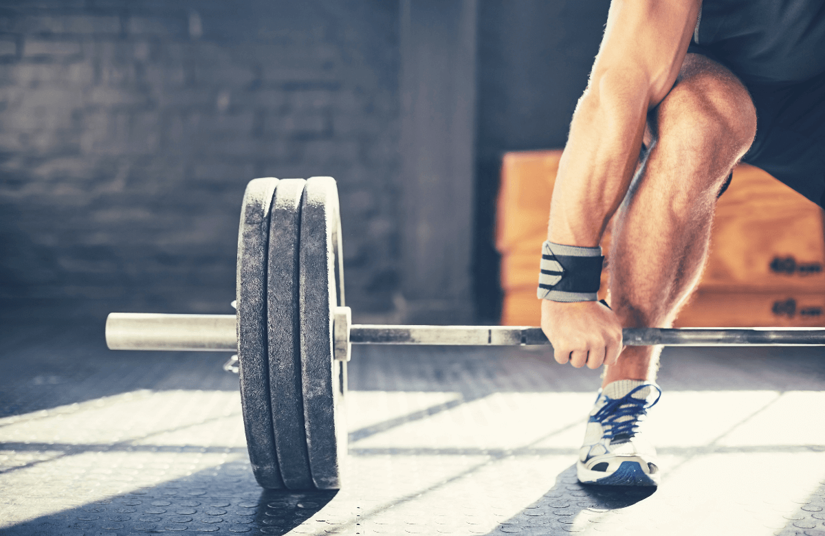 A ma, at the gym wearing deadlift accessories