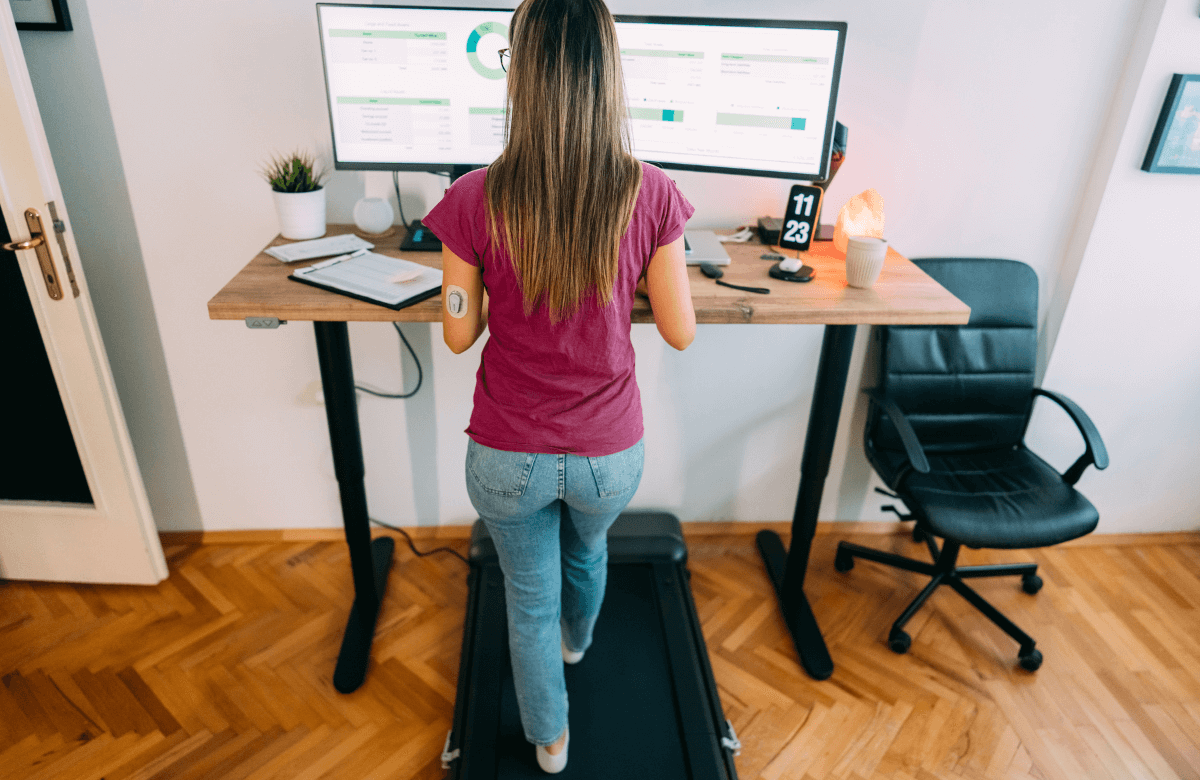A woman using the best under-desk treadmill at home