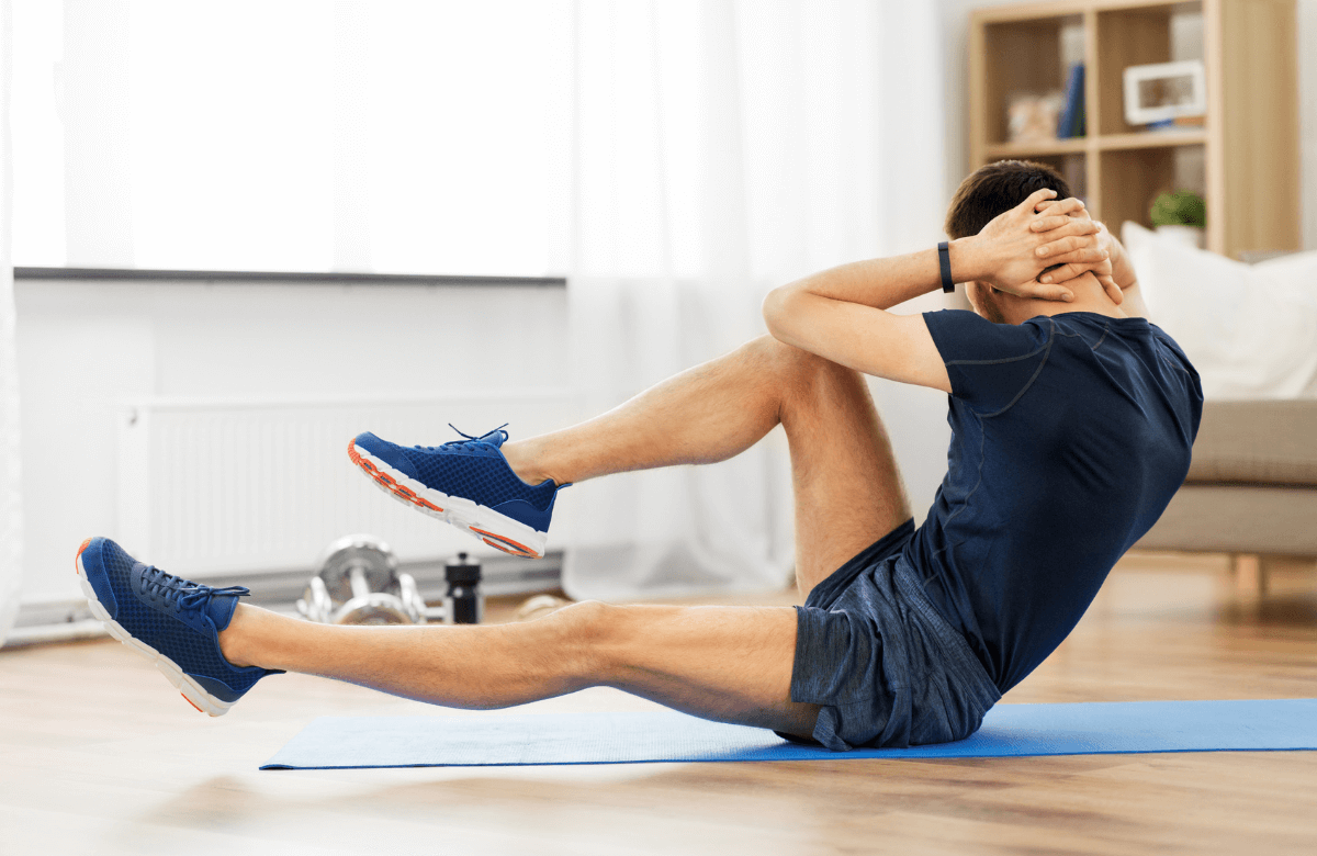 A man performing oblique crunches at home