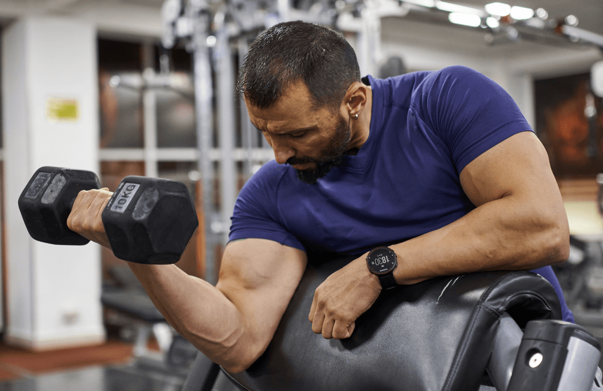 A strong man doing bicep curls