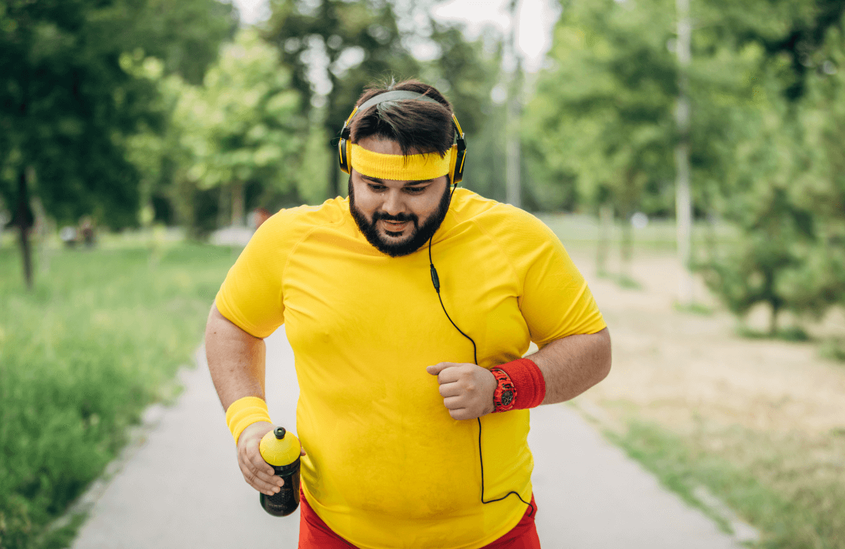 A fat man running following his workout plan to lose weight