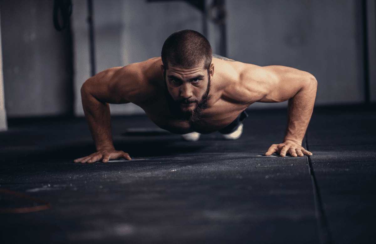 A man does pushups in a gym