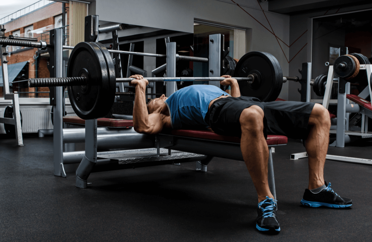 A man performs arch back bench press