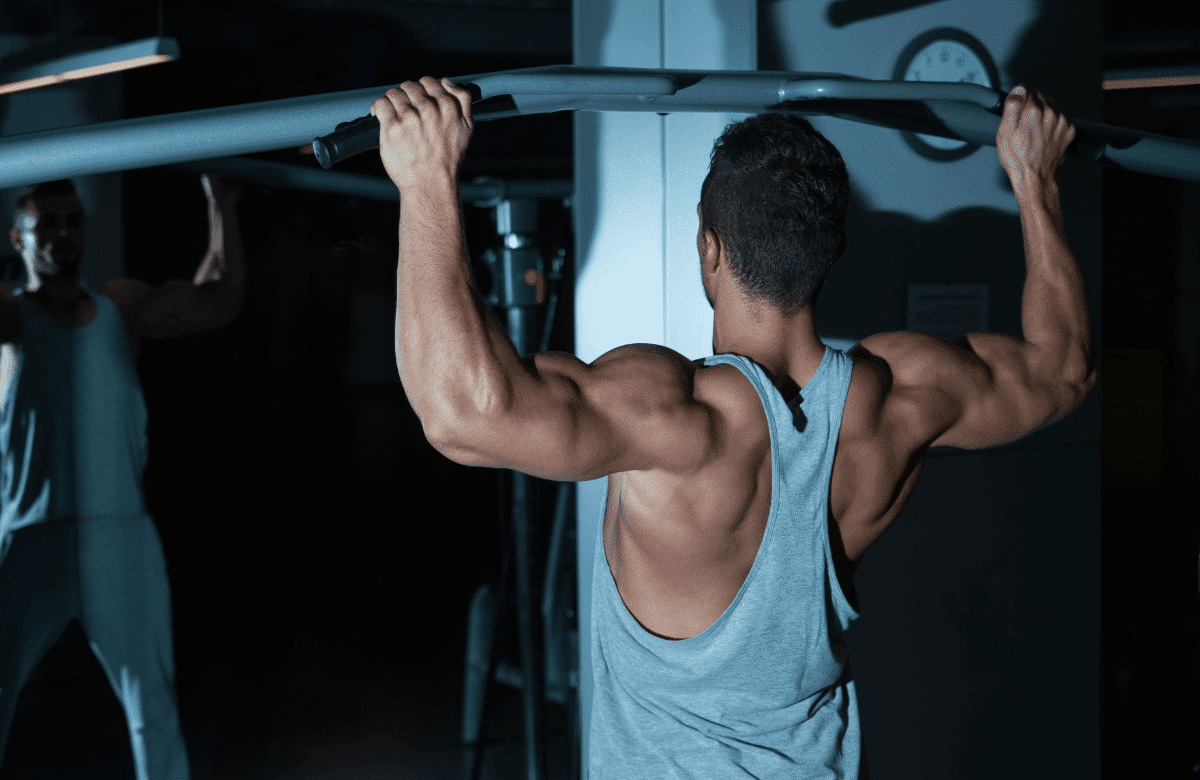 Man doing pull-ups, one of the best back exercises